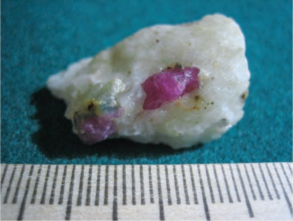 Vivid red ruby crystals in white calcitic marble matrix